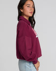 Side view of a woman wearing the Chaser 1986 Ski Club Long Sleeve on a neutral background with pants