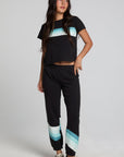 A full body front view of a woman wearing the Chaser Ada Black Jogger on a neutral background