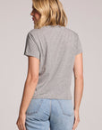Back view of a woman wearing the Chaser Allover Stars Tee on a neutral background