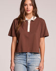 Front view of a woman wearing the Chaser Antoni Kahlua Tee and jeans on a neutral background