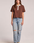 Front view of a woman wearing the Chaser Antoni Kahlua Tee and sneakers on a neutral background