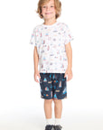 Full body view of the Chaser Kids Allover Sailboats Tee in white paired with the navy blue Allover Sailboats Shorts on a white background