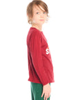 Side view of boy wearing Chaser’s Ski Club red pullover long sleeve with mountain silhouette graphic on a white background