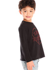 Side view of boy wearing Chaser’s Heartbreaker black long-sleeve shirt with red text and broken heart graphic on a white background