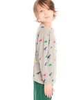 Side view of boy wearing Chaser’s Multi Dinos grey long sleeve top with colorful dinosaur patterns against a white background