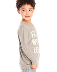 Side view of boy wearing Chaser’s Future World Leader gray long sleeve top with text graphic on a white background