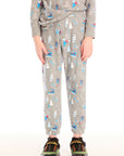 Boy wearing Chaser's gray Allover Ski Slope Pants and matching top with colorful patterns on a white background
