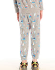 Back view of boy wearing Chaser's gray Allover Ski Slope Pants and matching top with colorful patterns on a white background