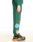 Side view of boy wearing Chaser’s Greatest Of All Time Everest Green pants on a white background