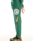 Side view of boy wearing Chaser’s Greatest Of All Time Everest Green pants on a white background