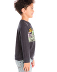 Side view of boy wearing Chaser's Allover Racing dark gray sweatshirt with colorful graphic design on a white background