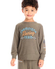 Boy wearing Chaser’s Safari Green Champions Racing Team long sleeve top with matching pants on a white background