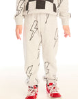 Boy wearing Chaser's gray Allover Bolts pants with lightning bolt designs and on a white background