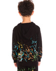 Back view of boy wearing Chaser’s Paint Splatter black hoodie with colorful splatter design and hood up on a white background