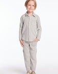 Full body view of boy wearing Chaser’s heather grey Knee Seam Joggers with waffle texture and matching top on a white background