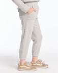 Side view of boy wearing Chaser’s heather grey Knee Seam Joggers with waffle texture against a white background