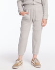 Front view of boy wearing Chaser’s heather grey Knee Seam Joggers with waffle texture against a white background