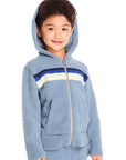 Boy wearing Chaser’s Paxton Zip Up true blue hoodie with hood up and a colorful stripe on a white background