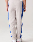 Model wearing Chaser's Sporty Colorblock Boys Lounge Pants in heather grey with colorblock detailing, detail view