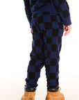 Back view of boy wearing Chaser’s blue checkered Lounge Pant against a white background