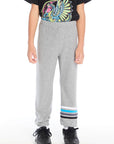 Front view of boy wearing Chaser Kids Heather Grey Joggers with blue, white, and navy stripe detail at the cuff, paired with the Rolling Stones Dragon Tee on a white background