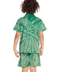 Back view of boy wearing the Chaser Kids Wild Green Tie Dye Polo Shirt featuring a large spiral tie dye pattern across the back, paired with matching shorts on a white background