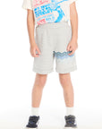 Front view of boy wearing the Chaser Kids Peace Out Shorts in Heather Grey featuring blue wave graphics near the hem, paired with an Elvis Presley graphic tee on a white background
