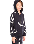 Boy wearing Chaser’s Smileys navy blue zip up hoodie and hood up with white smiley face patterns and matching pants on a white background