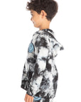 Side view of boy wearing Chaser’s Smiley Bolt tie-dye zip up hoodie with smiley face lightning bolt graphic on a white background