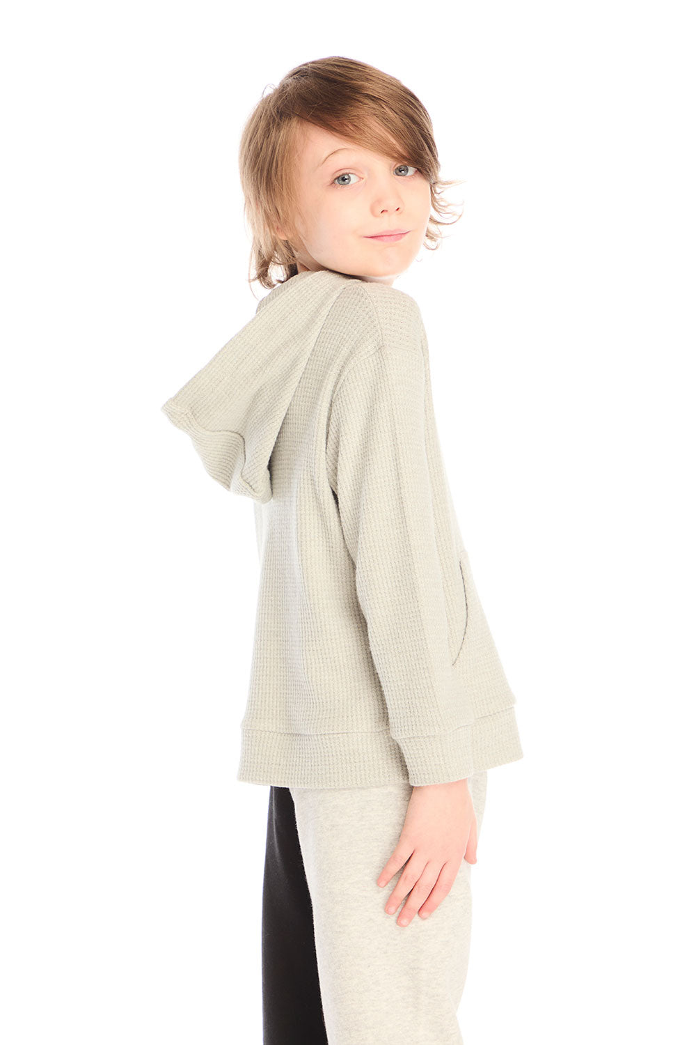 Side view of boy wearing Chaser’s Heather Grey Zip Up Hoodie with waffle texture against a white background