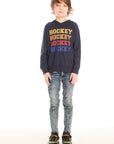 Full body view of boy wearing Chaser’s Hockey navy blue pullover hoodie with ‘Hockey’ text and distressed jeans on a white background