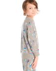 Side view of boy wearing Chaser's gray Allover Ski Slope long sleeve and matching pant with colorful patterns on a white background