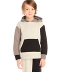 Boy wearing Chaser’s color-blocked long sleeve hoodie with matching pants on a white background