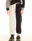Front view of boy wearing Chaser’s Colorblocked Lounge Pant with color-blocked panels on a white background