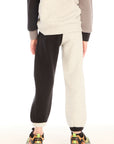 Back view of boy wearing Chaser’s Colorblocked Lounge Pant with color-blocked panels on a white background