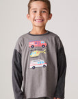Model wearing Chaser's Heroes Boys Long Sleeve Tee in charcoal with first-responder vehicle graphics, front view