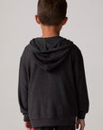 Model wearing Chaser's Vintage Black Stripe Boys Zip-Up Hoodie in Black with striped detailing, back view