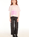 Full body view of girl wearing Chaser’s light pink Love Tee with ‘LOVE’ printed in pink and dark jeans on a white background