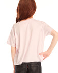 Back view of girl wearing Chaser’s light pink Love Tee in light pink on a white background