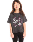 Young girl wearing Chaser’s Best Sister black tee on a white background