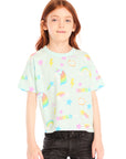 Girl wearing Chaser’s light green Unicorn Hearts Tee with text and colorful graphics against a white background
