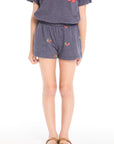 Girl wearing the Chaser Kids Allover Cherries Shorts in Avalon Blue with allover cherry print on a white background