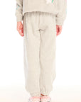 Back view of girl wearing Chaser’s light gray Winter Love Pants on a white background
