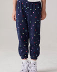 Model wearing Chaser's Festive Lights Girls Pants in Avalon with distinctive graphic and design details, front view
