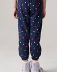Model wearing Chaser's Festive Lights Girls Pants in Avalon with distinctive graphic and design details, back view