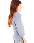 Side view of girl wearing Chaser’s blue-gray Pastel Love Bolt Long Sleeve with colorful “LOVE” design on a white background