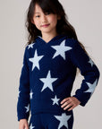 Model wearing Chaser's Allover Stars Girls Hoodie in lake blue with star detailing, back view