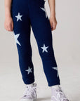 Model wearing Chaser's Allover Stars Girls Pants in lake blue with star detailing, front view