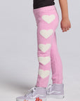 Chaser Kids Holiday Hug Girls Pants in pink with white hearts down one leg, side view against a light gray studio background