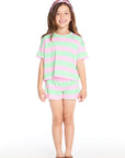 Girl wearing the Chaser Kids Pinky Aloe Stripe Jade Short paired with the matching Pinky Aloe Stripe Devin Tee, styled with sandals and a metallic pink headband on a white background